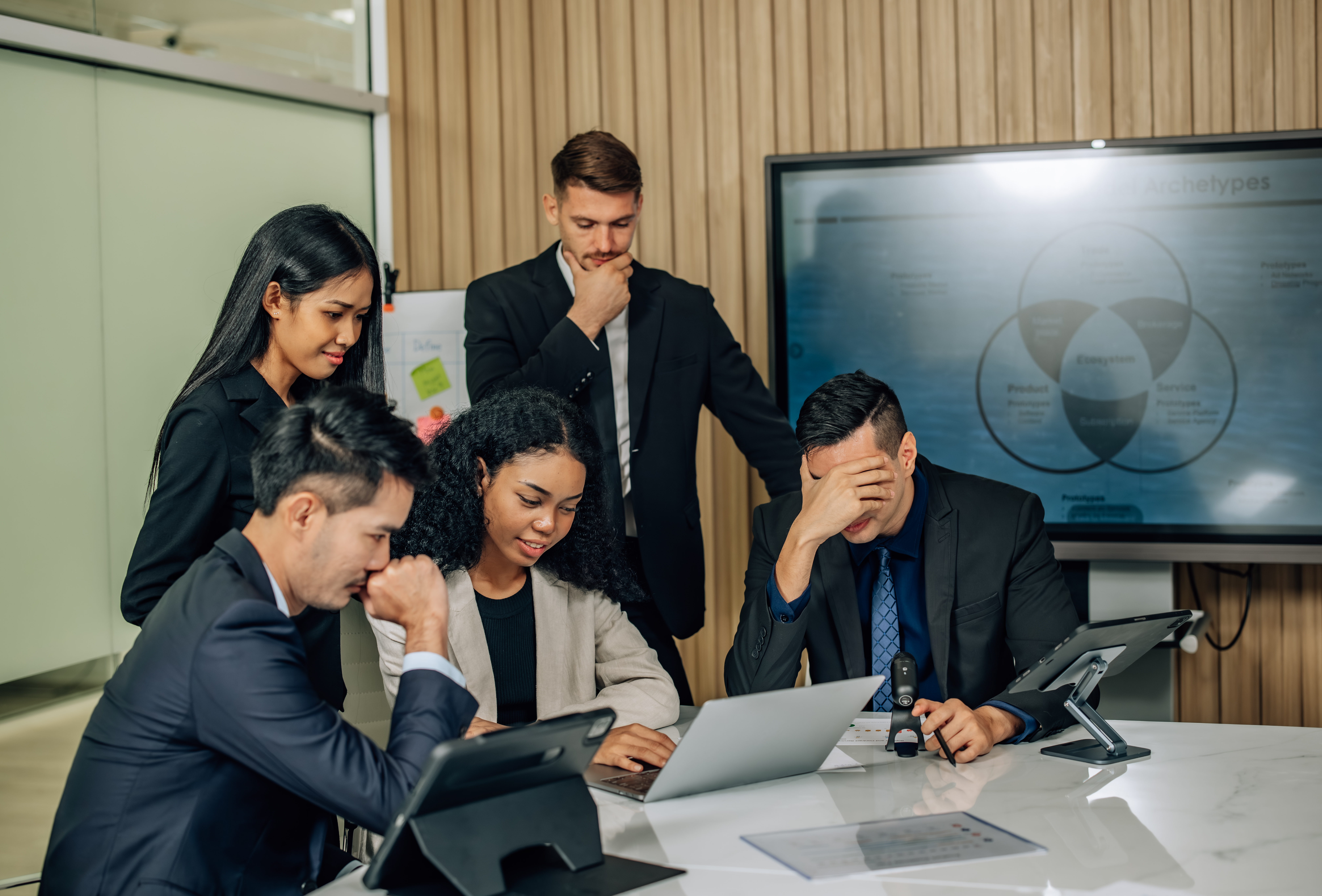 A sales team having a serious meeting about product knowledge.